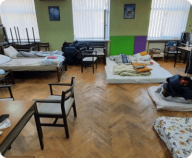 Shelter with beds and cots for displaced families