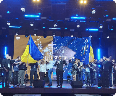 Worship event with Ukrainian flags on stage