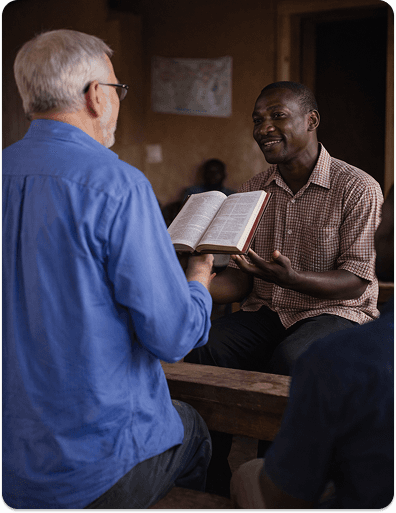 A pastor sharing the Bible with a fellow minister