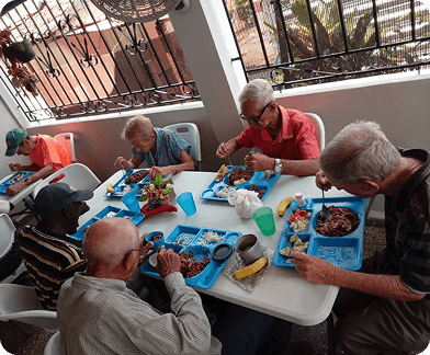 Elderly community members sharing a meal at the Ivory Coast refugee camp