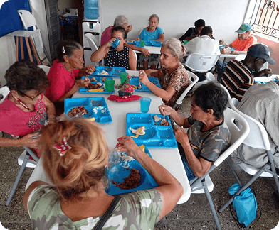 Refugees gathered together at a meal in the Ivory Coast camp
