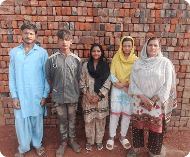 A freed family standing together outside their home